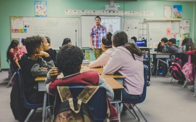 Image of an elementary school classroom with students and teacher