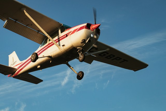 Image of a small prop plane in the air