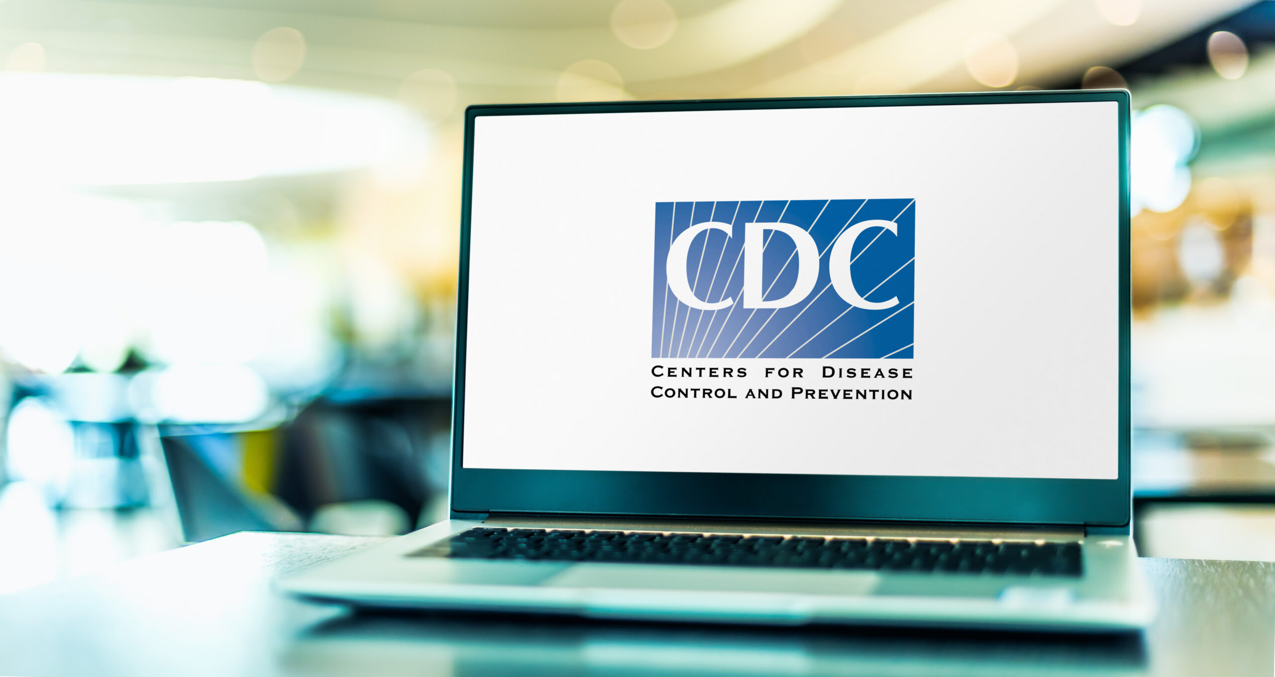 An open laptop sitting on a table with the CDC logo on the screen